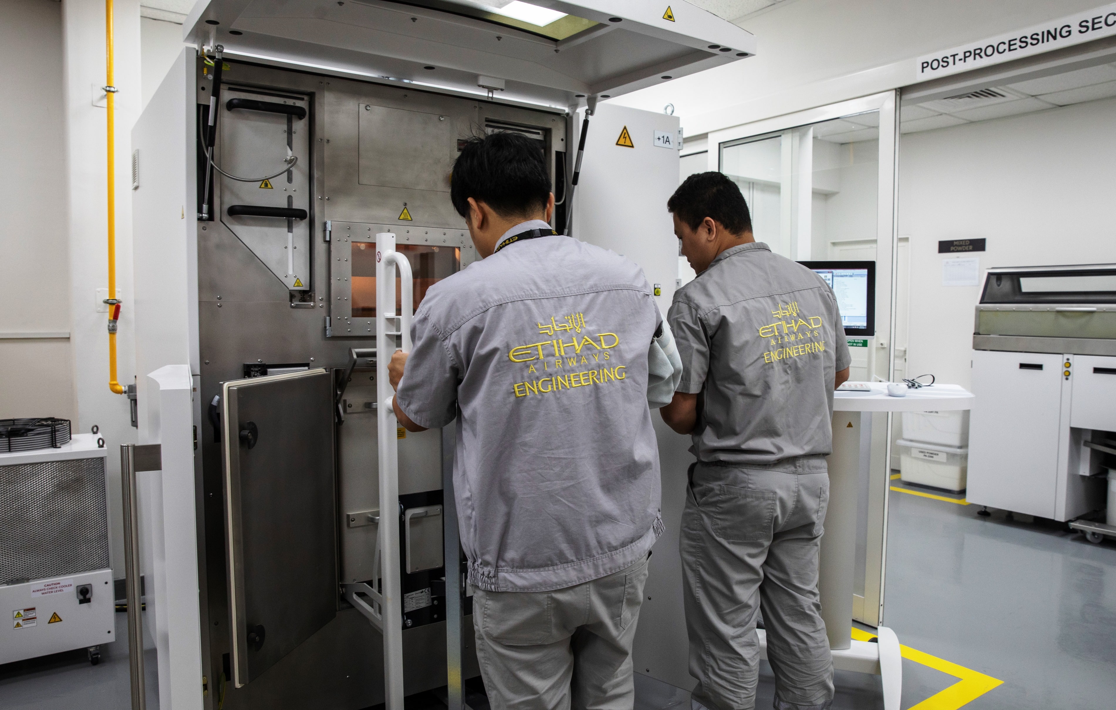 Etihad Engineering engineers at work using the pioneering EOS Additive Manufacturing 3D Printer which is now located at Etihad Engineering’s facility located in Abu Dhabi. (Source: Etihad Aviation Group)